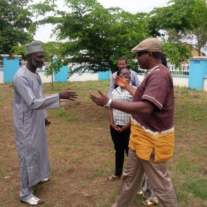 B. M. Dzukogi and amu nnadi going for hug-shakes; Shade Mary-ann Olaoye watching with Chiedu Ezeanah